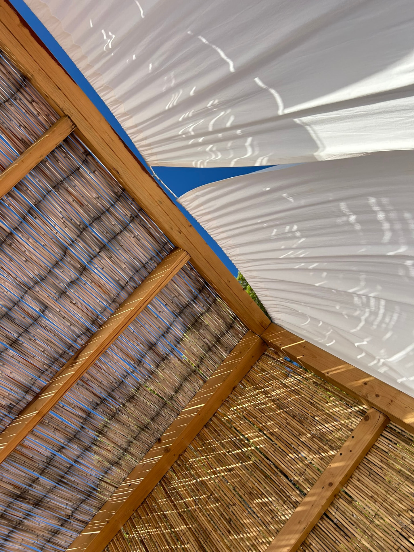 Bamboo wall of a cabana with the turquoise sea in the background